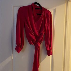 Pink keyhole blouse with belt around the waist